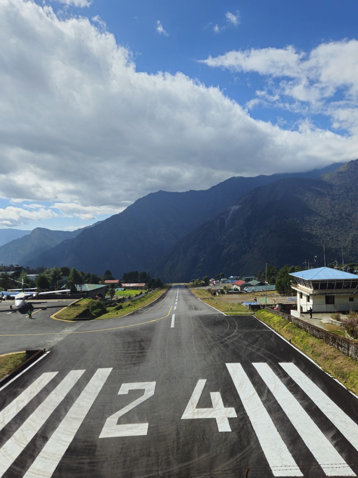 The mountain runway at Tenzing-Hillary Airport in Lukla beneath large clouds